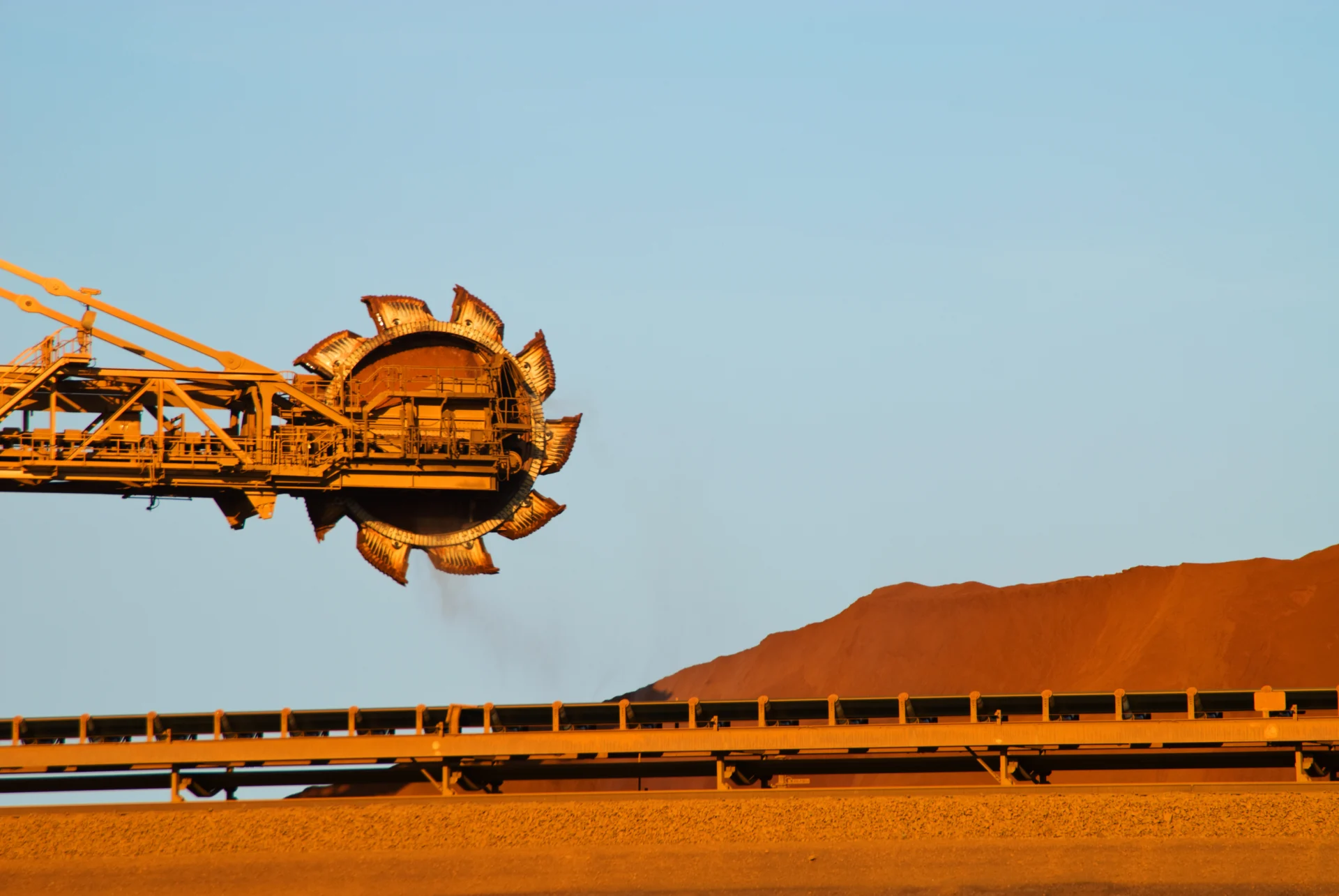 A crane lifts a large heap of sand, illustrating the machinery's function in construction and material handling tasks.