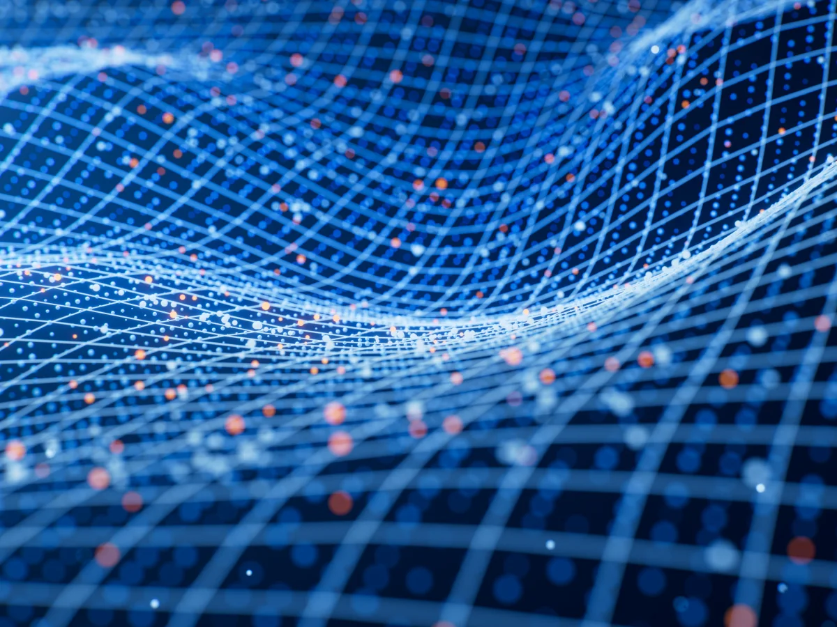 A solid blue surface adorned with a multitude of dots in different colors and sizes, in a wave-like movement 