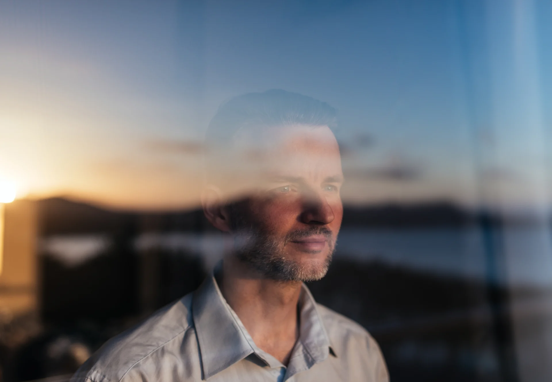 Man looking out window