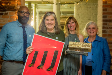 Laurie Feinberg receives the Larry Reich Award. Left to Right: Board President Evan Richardson, Laurie Feinberg, Executive Director Jennifer Goold, Sandy Sparks. Photo by Marcus Ervin.