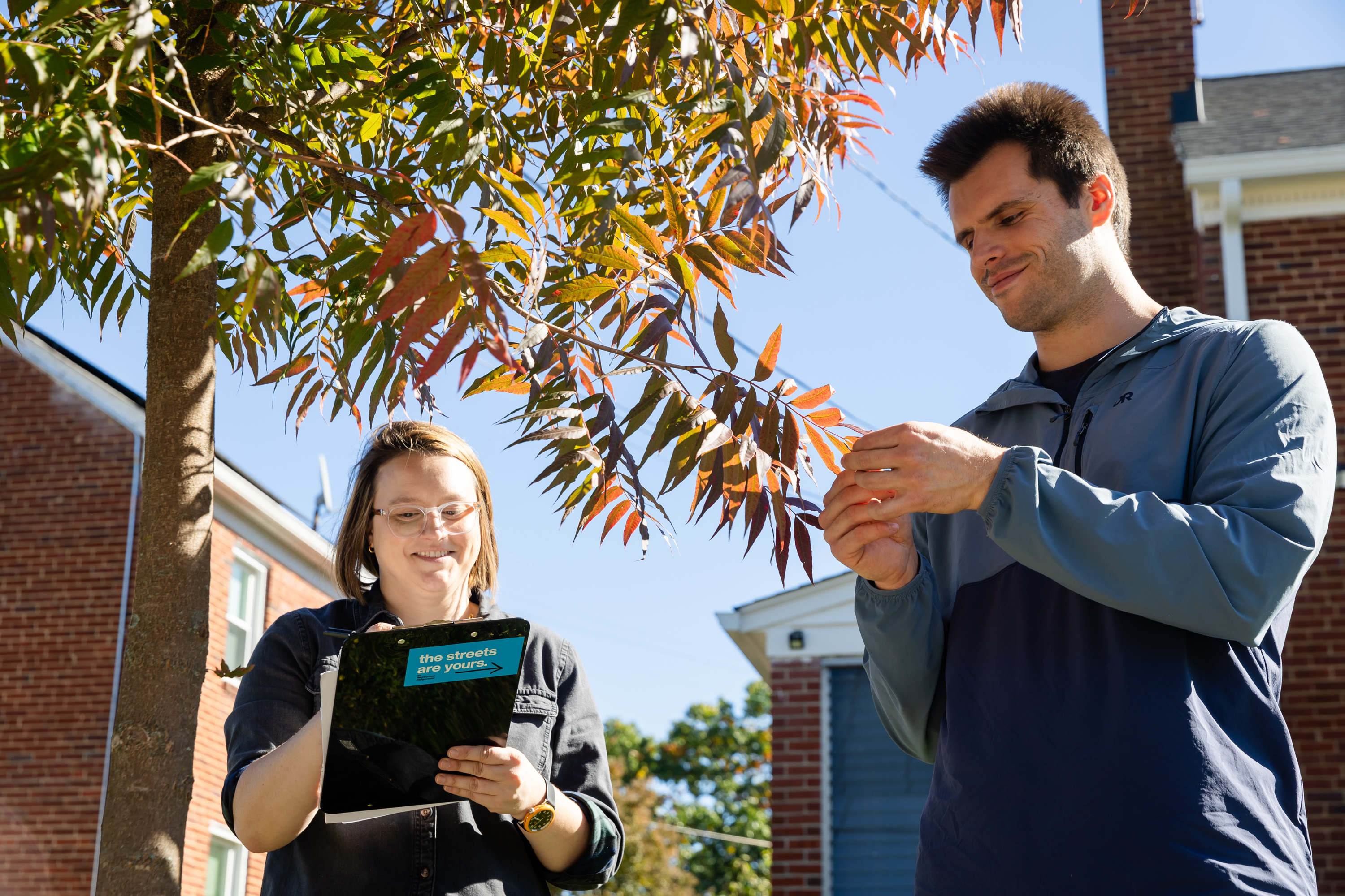 Laura Robinson, Programs Director, and Collin Breidenbach, Project Manager, from our Landscape Design and Environmental Resilience team, maintain neighborhood trees.

