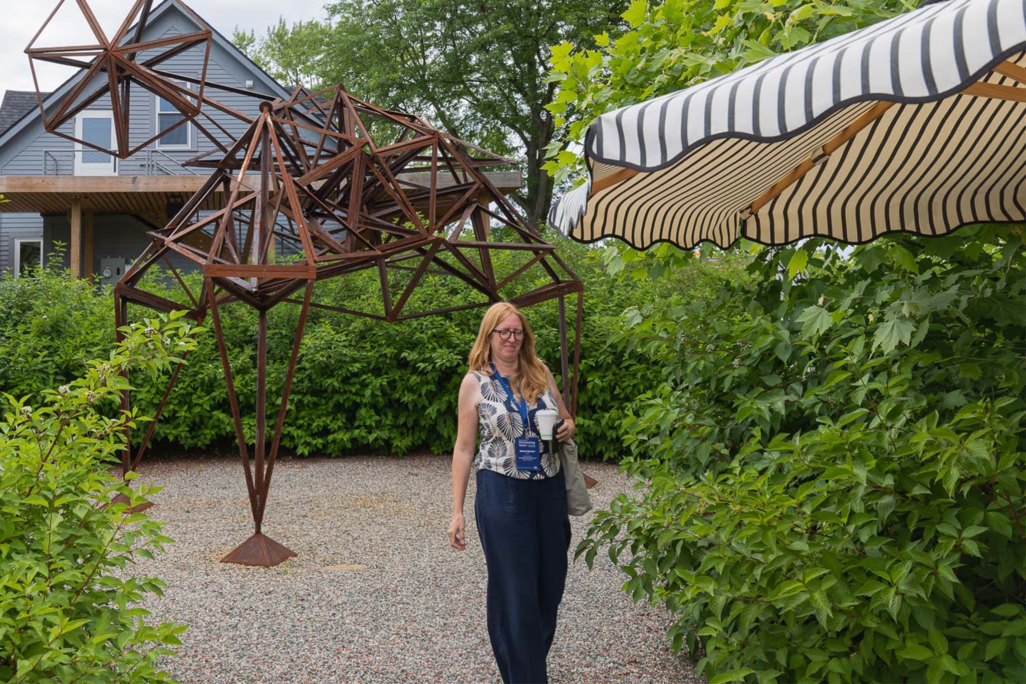 Briony walking through sculpture garden at Placemaking Week 2026 Detroit by Chris Ahern.