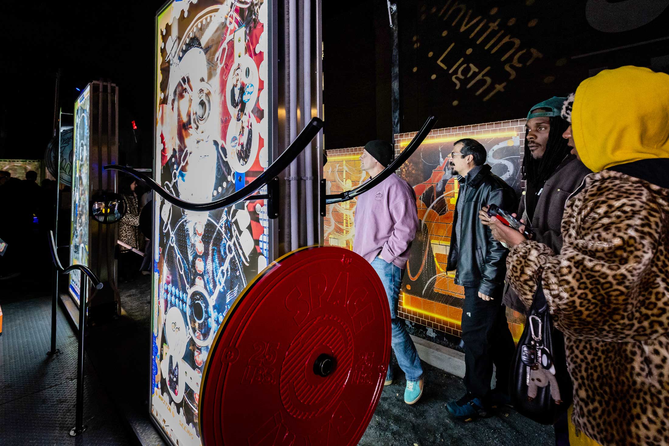 Soft Gym by Wickerham and Lomax, an Inviting Light installation at YNOT LOT in Station North Arts District. Attendees interact with the illuminated sports-themed art equipment.