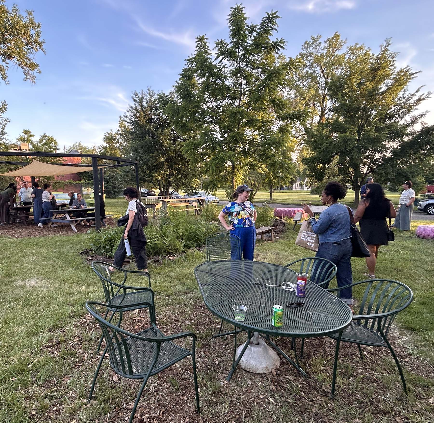 Gathering attendees in vibrant grassy space for Design Futures