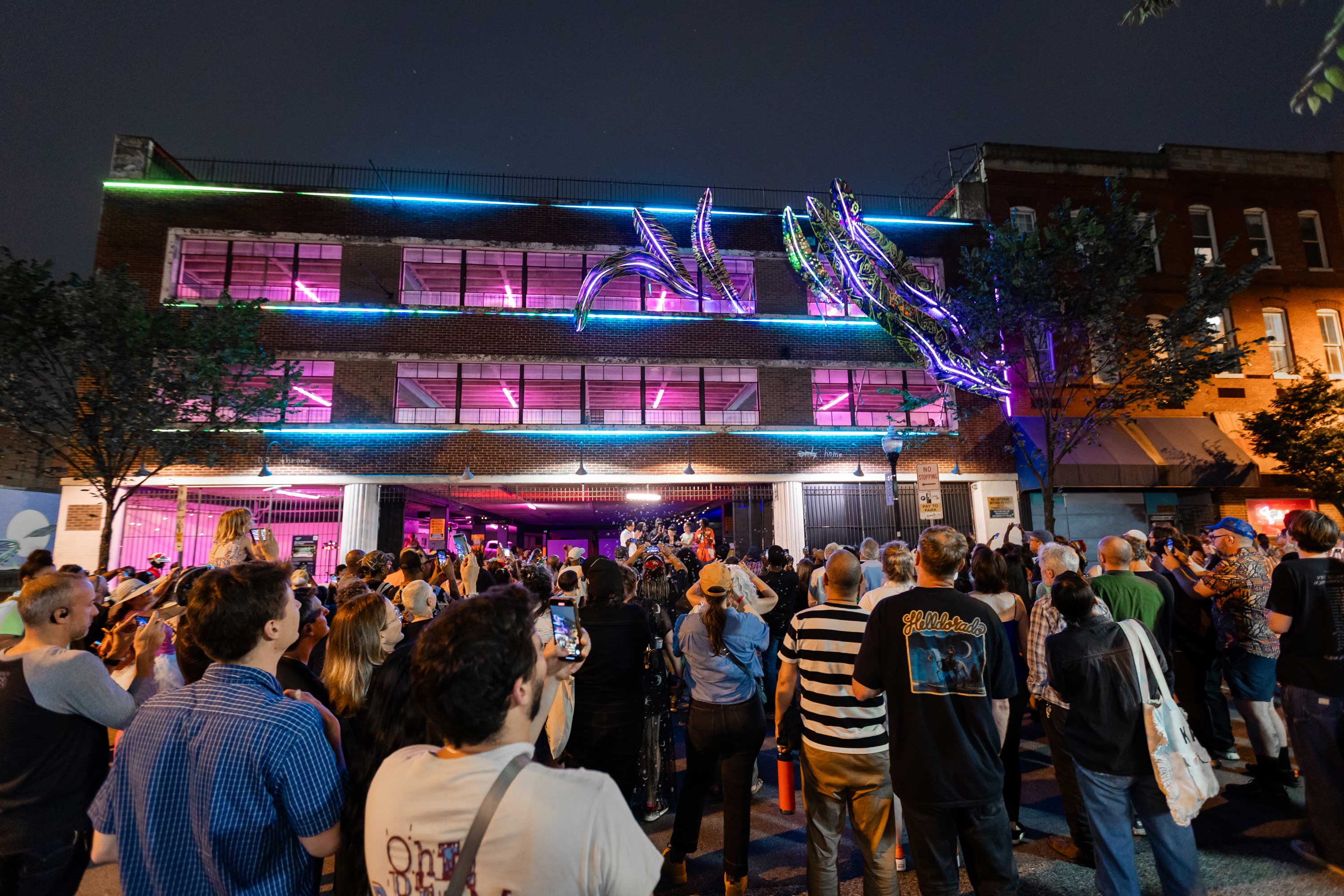 Big Ass Snake(Plant)s On A Plane by Phaan Howng. Playing off big action movies, Phaan is turning the Charles St. Garage into an over-the-top light-filled action movie– right across from the Charles Theatre.


