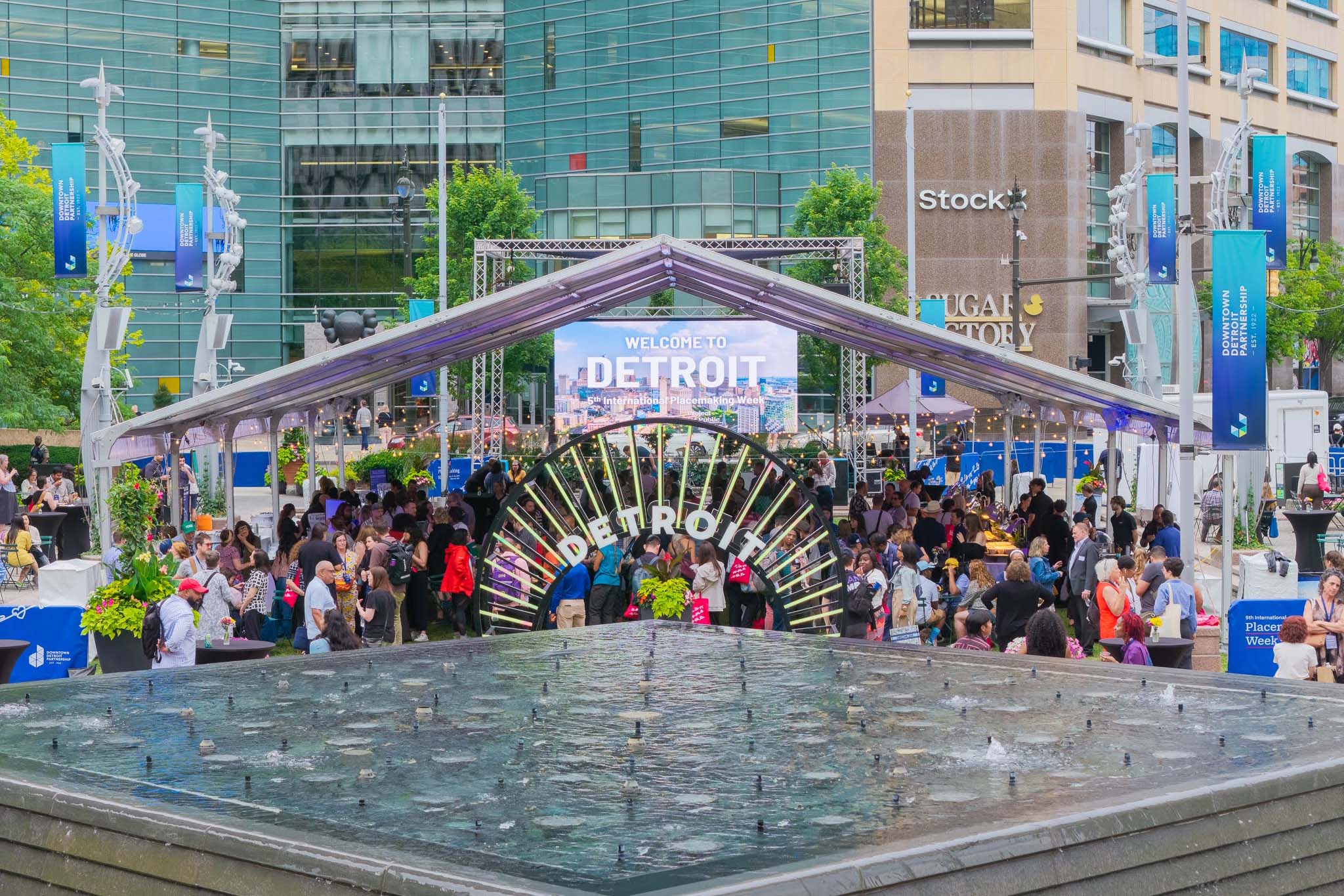 Vibrant outdoor pavilion with fountain and art at Placemaking Week 2026 Detroit by Chris Ahern.