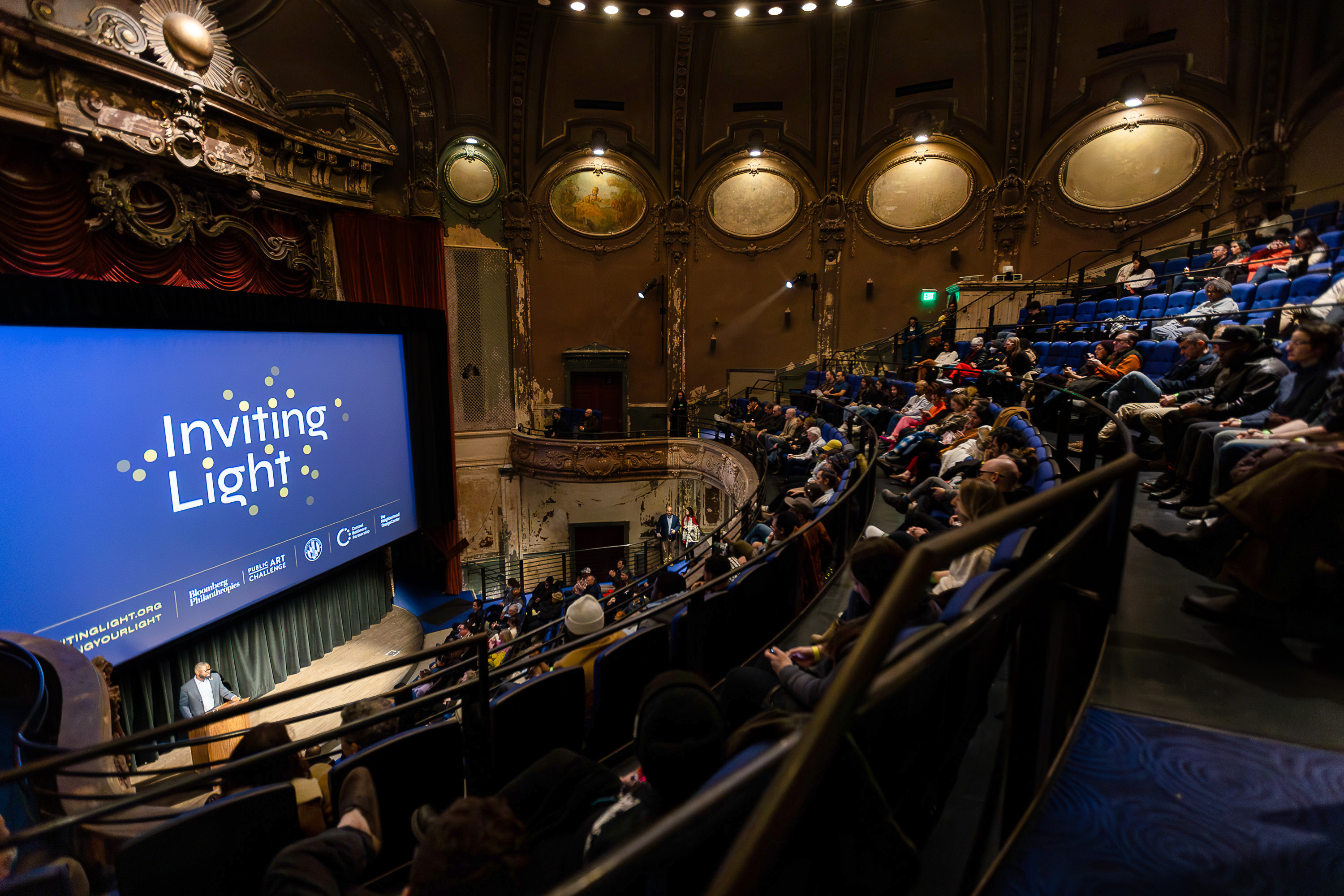 A packed room at the Parkway Theatre for the Inviting Light Community Kick-off Event that unveiled the artists’ designs. Photos by Side A Photography.