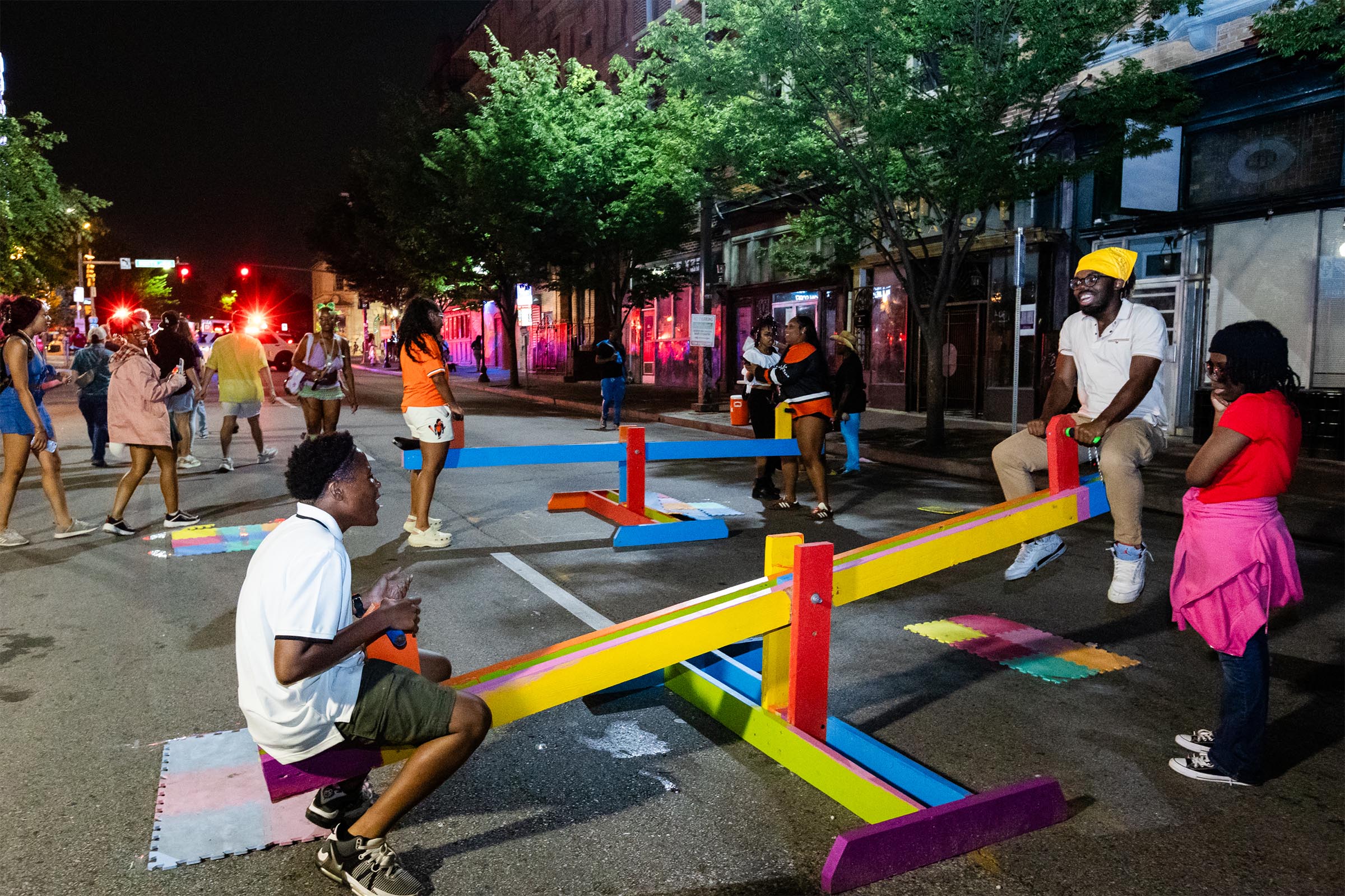 Participants get in touch with their silly side on adult-sized teeter-totters, side across from friends and strangers alike.