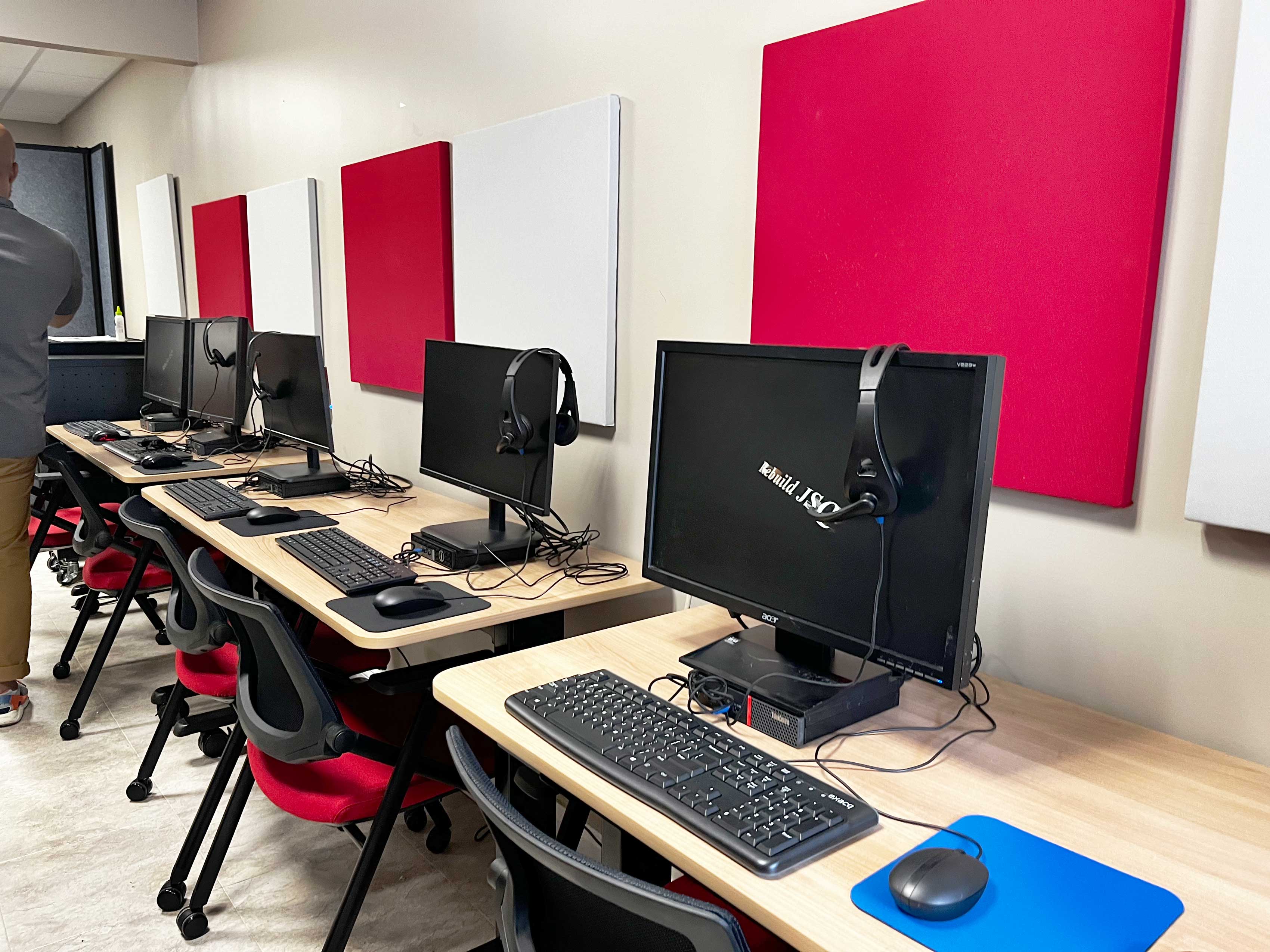 Computers at desk stations in community lab.