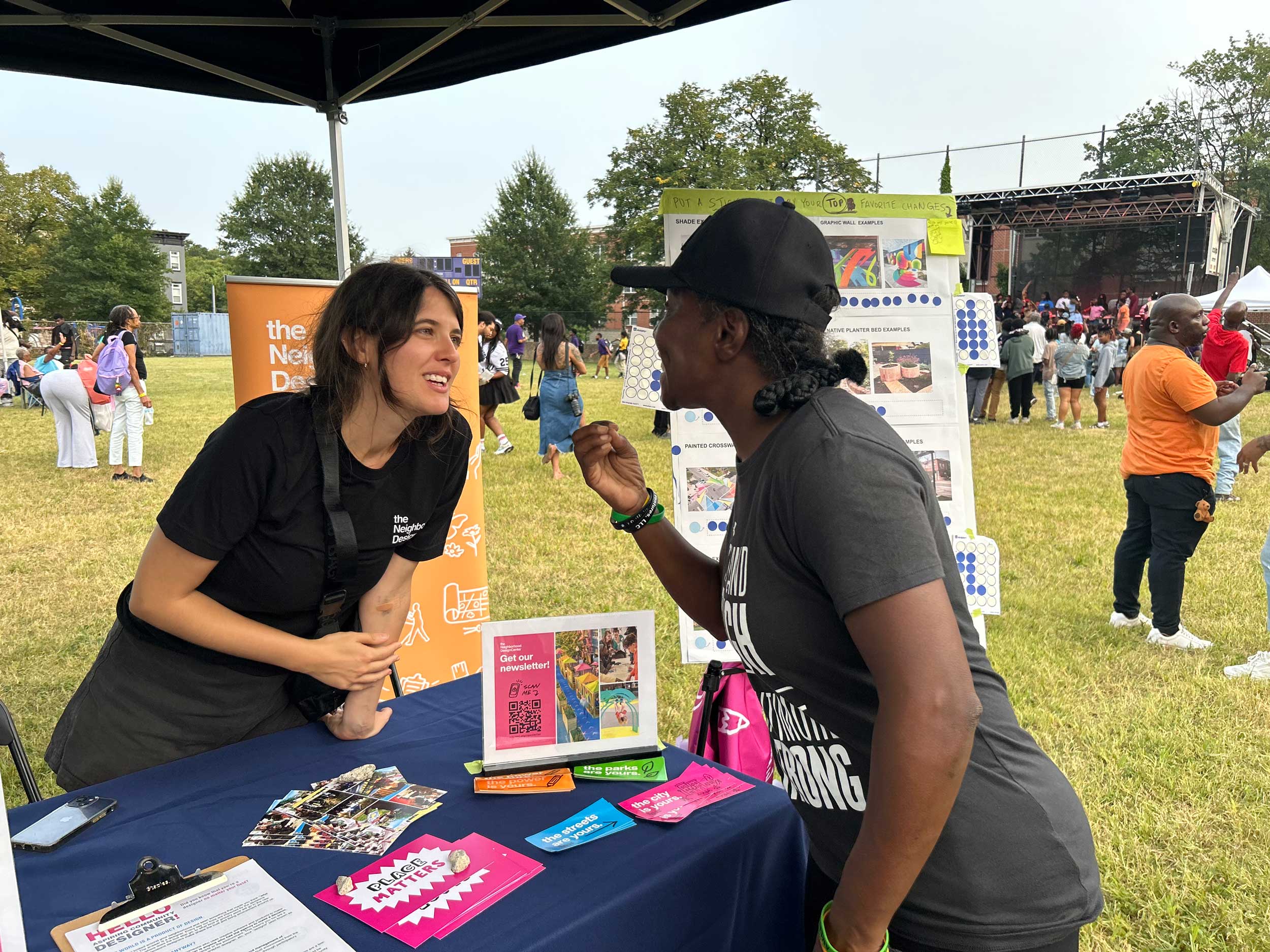 NDC staff discuss the YO Baltimore facade improvements project with residents.