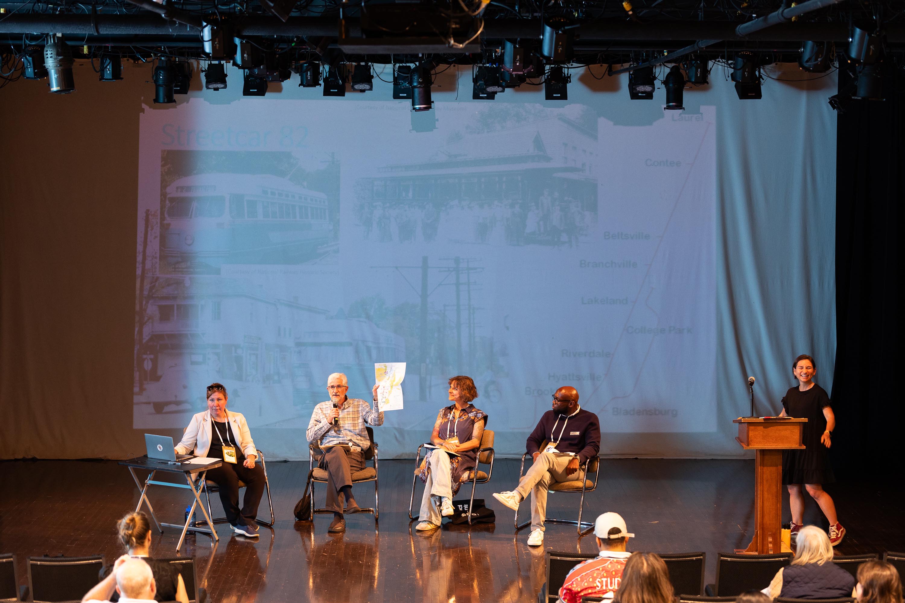 The Vision is Yours Placemaking and Placekeeping Conference 2026: four speakers seated on the main stage discussing transportation.