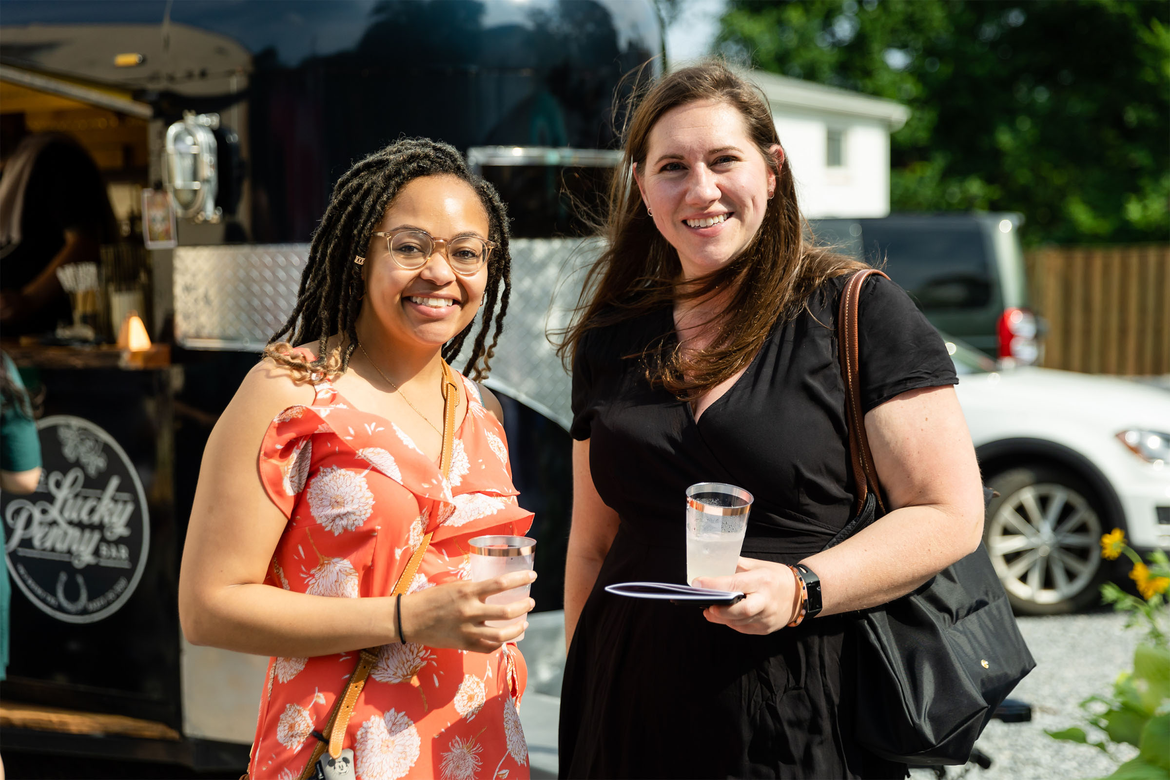 Board members celebrating at outdoor event.