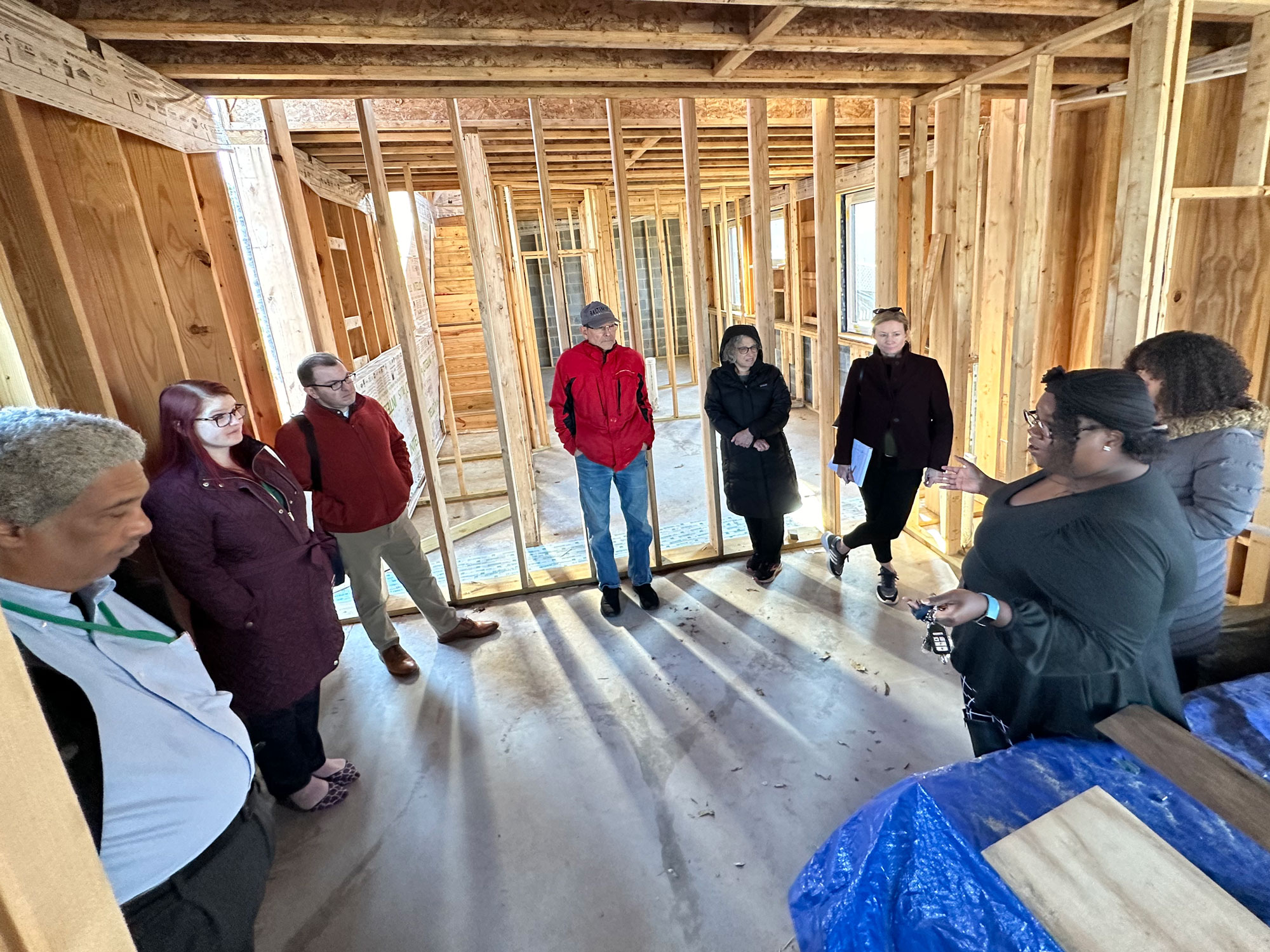 Stakeholders touring framing inside passive house. Photo courtesy of Jason Neal.