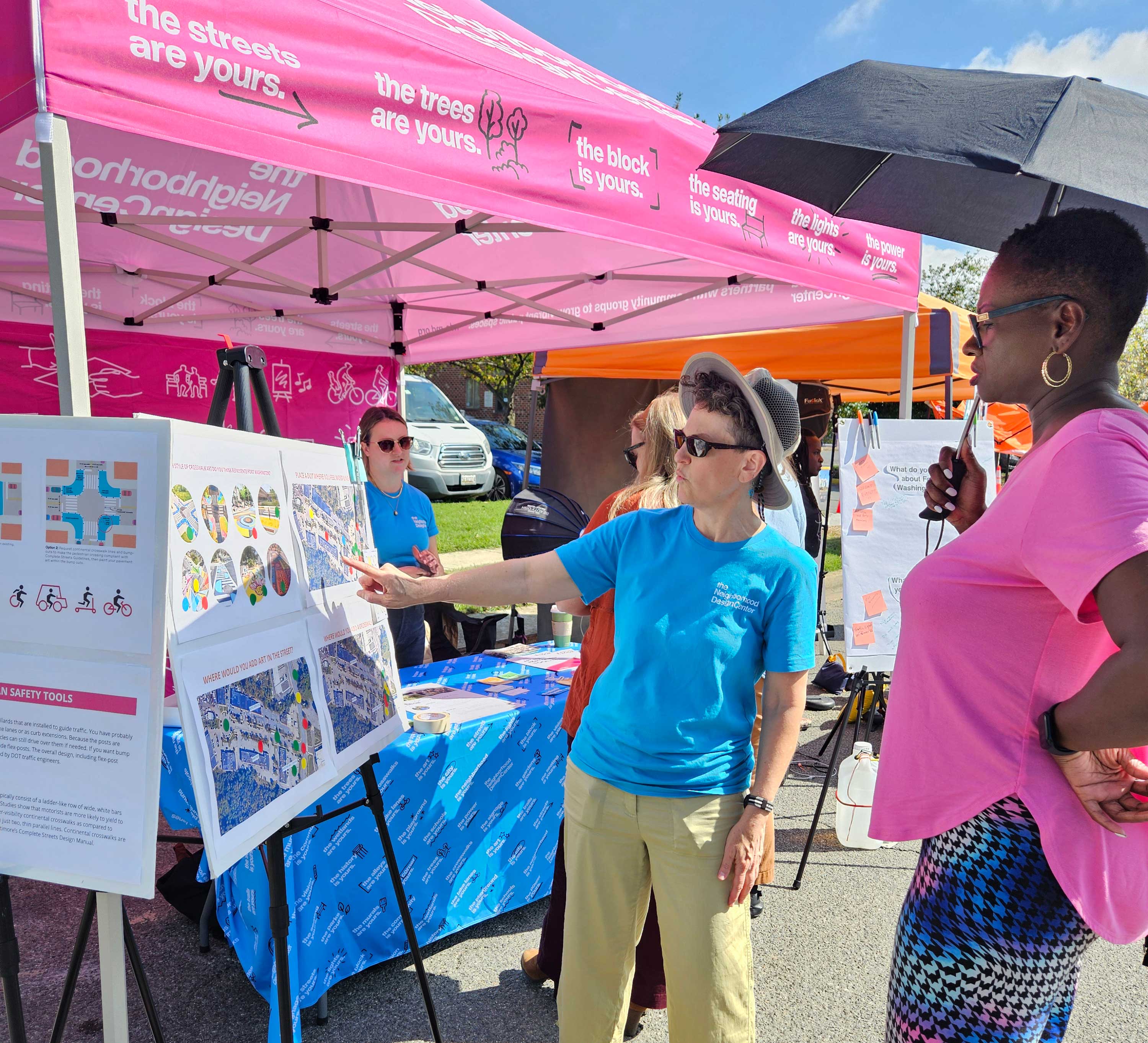 NDC staff at tabling event talking with Prince George’s County residents about how Art in the Right of Way projects can make communities safer.