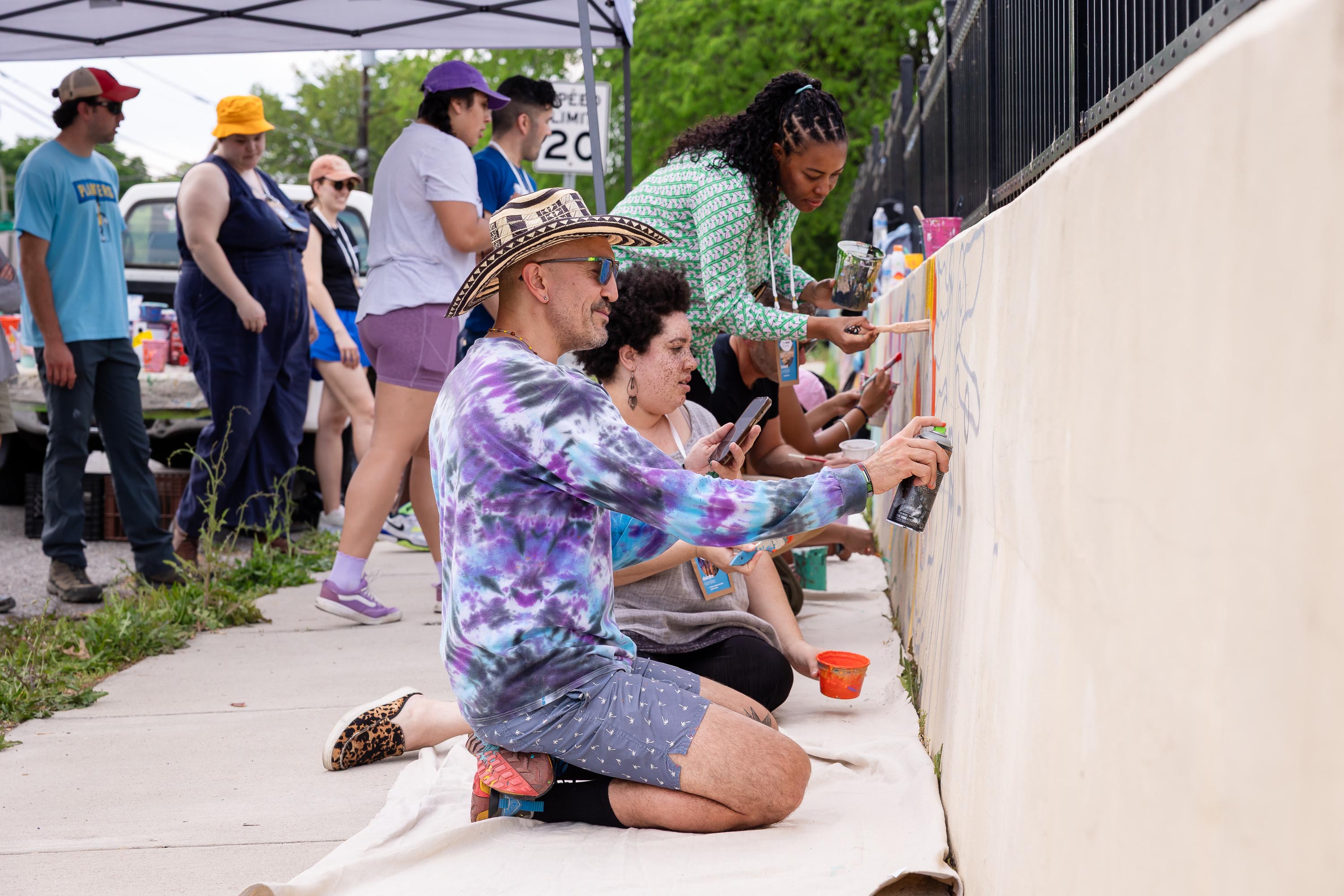 The Vision is Yours Placemaking and Placekeeping Conference 2026: attendees and artist blocking in mural.