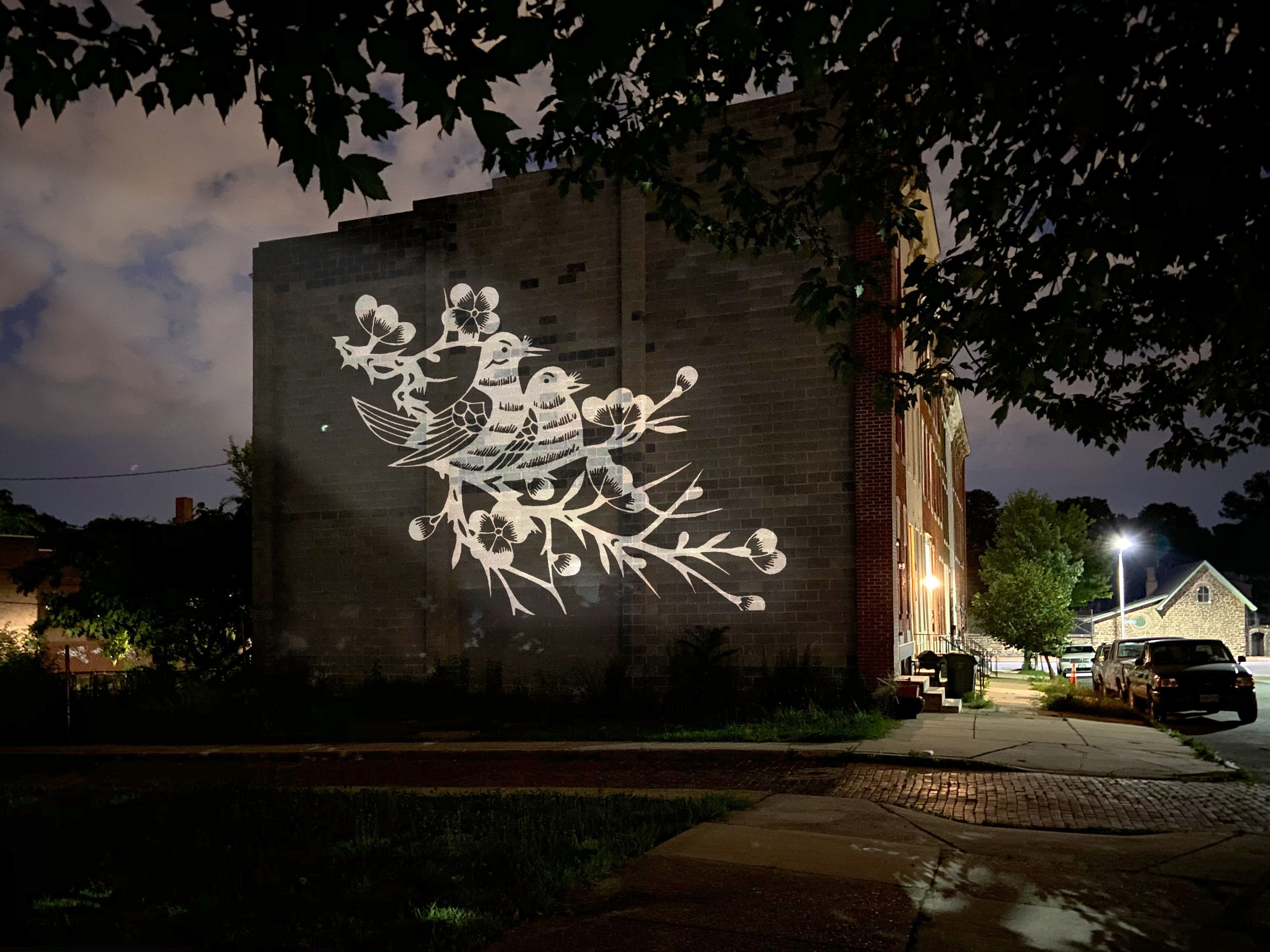 PROJECT: SIGNAL LIGHT GALLERY (PUBLIC MECHANICS) Carrying forward the District’s history of public murals, Signal Light Gallery, a concept developed by Public Mechanics, brings the luminous work of artists to neighborhood walls through a rotating “gallery” of curated outdoor projections. It supports community gathering, provides opportunities for local artist contribution, and establishes district identity.