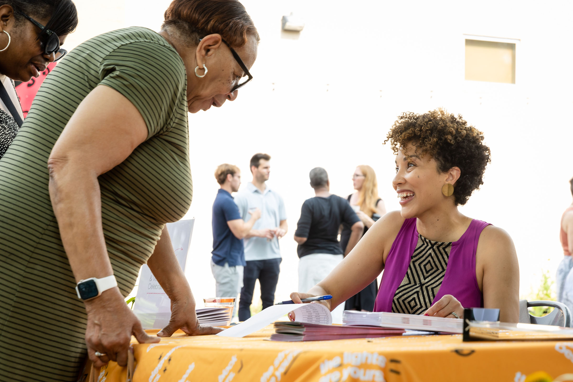 Board member welcoming guests to annual celebration.