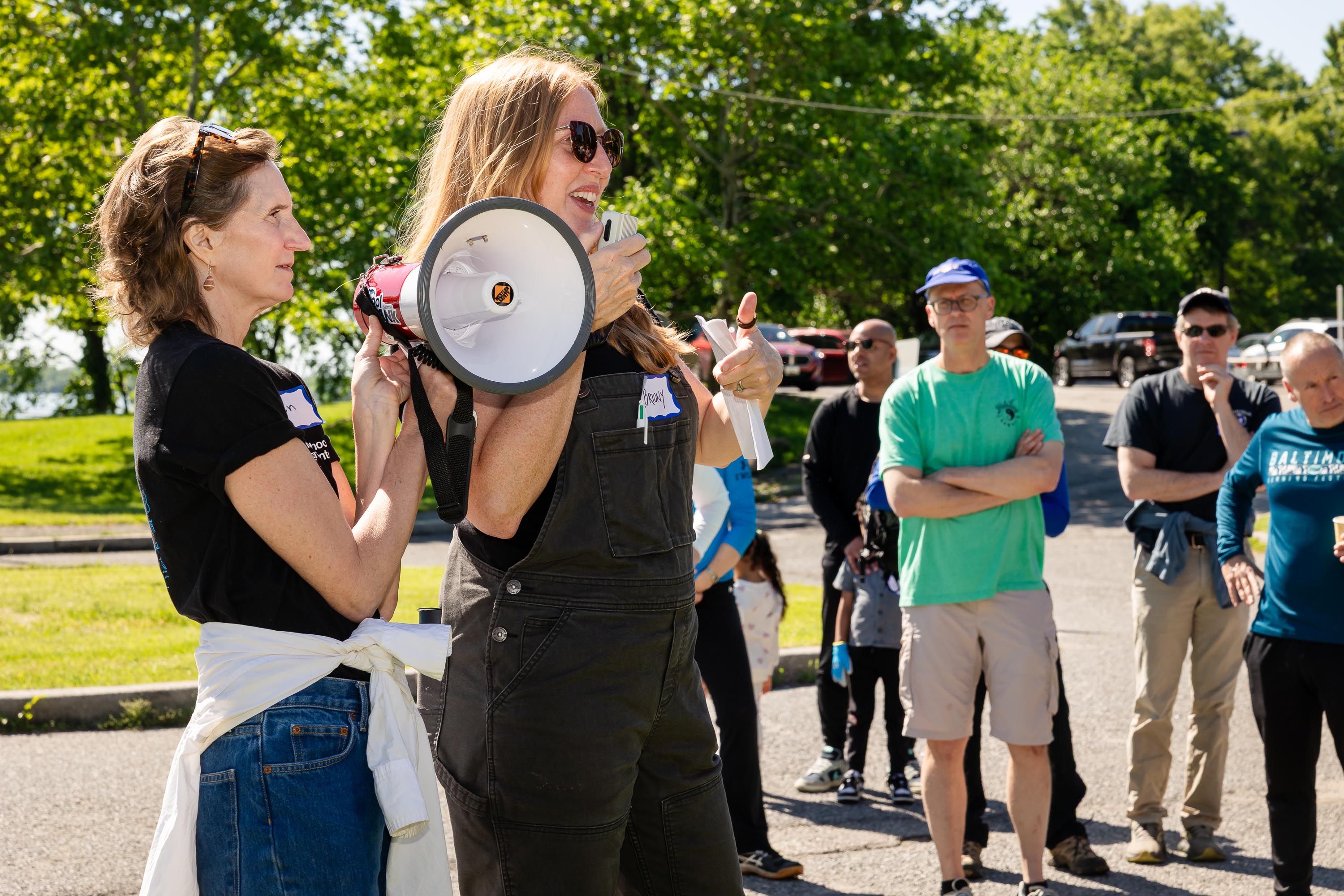 Briony at megaphone in front of crowd before trash dash begins.
