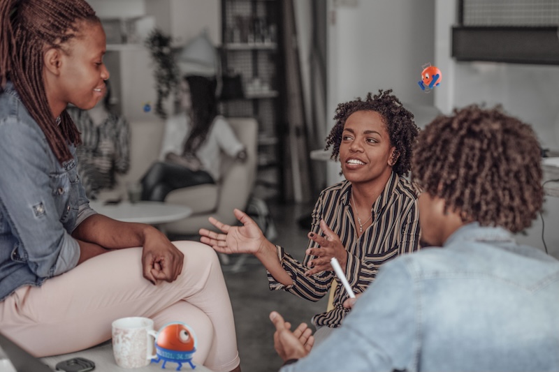 Three people having a conversation