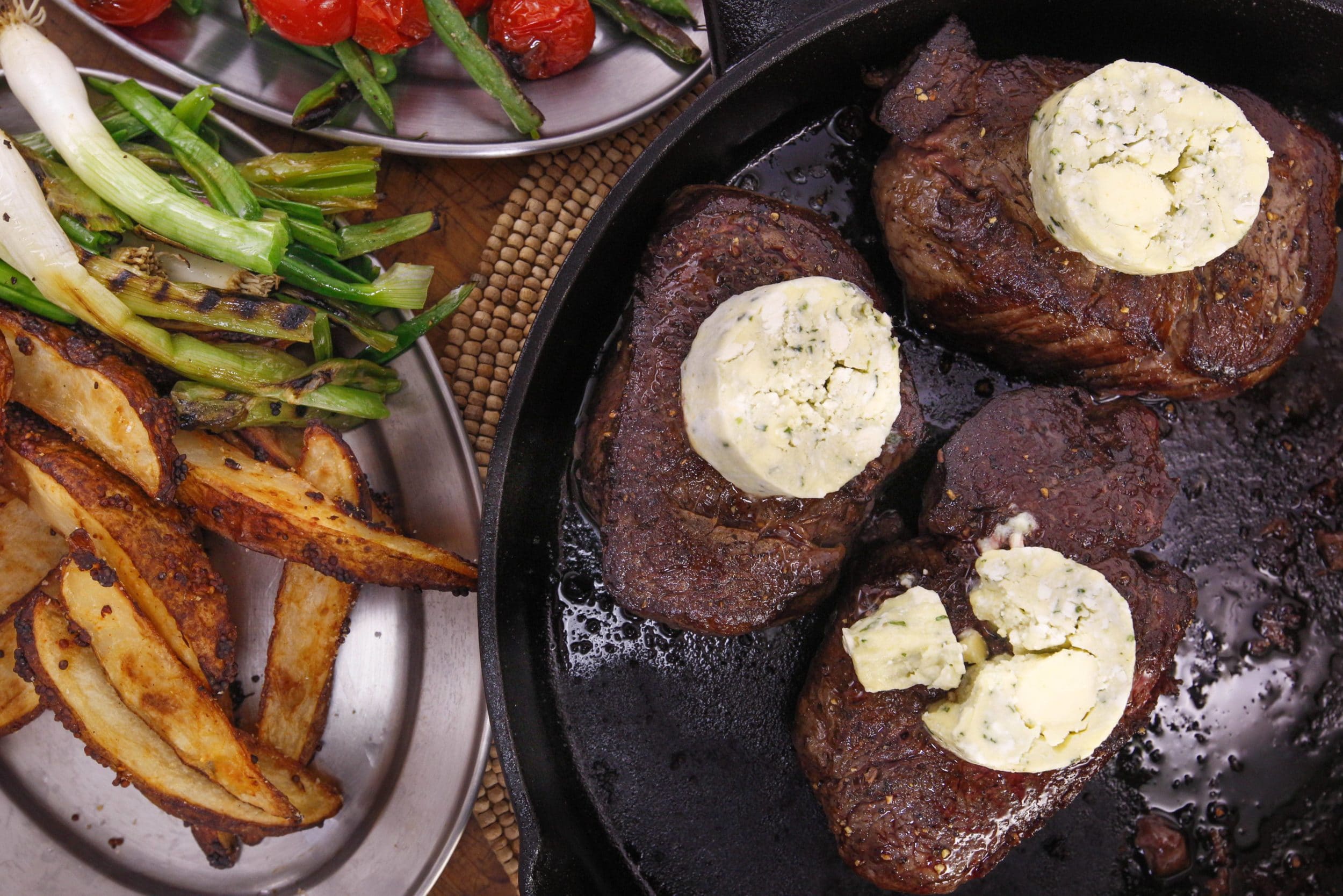 Steaks with Blue Tarragon Butter and Charred Green Onions