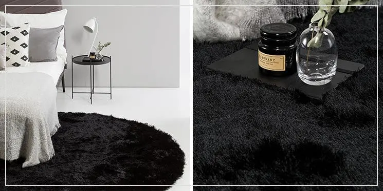 Kontrastreiches Schlafzimmer eingerichtet in Schwarz-Weiß mit rundem, schwarzen Hochflorteppich auf weißen Fliesen und einem grauen Bett mit Bettwäsche in Creme