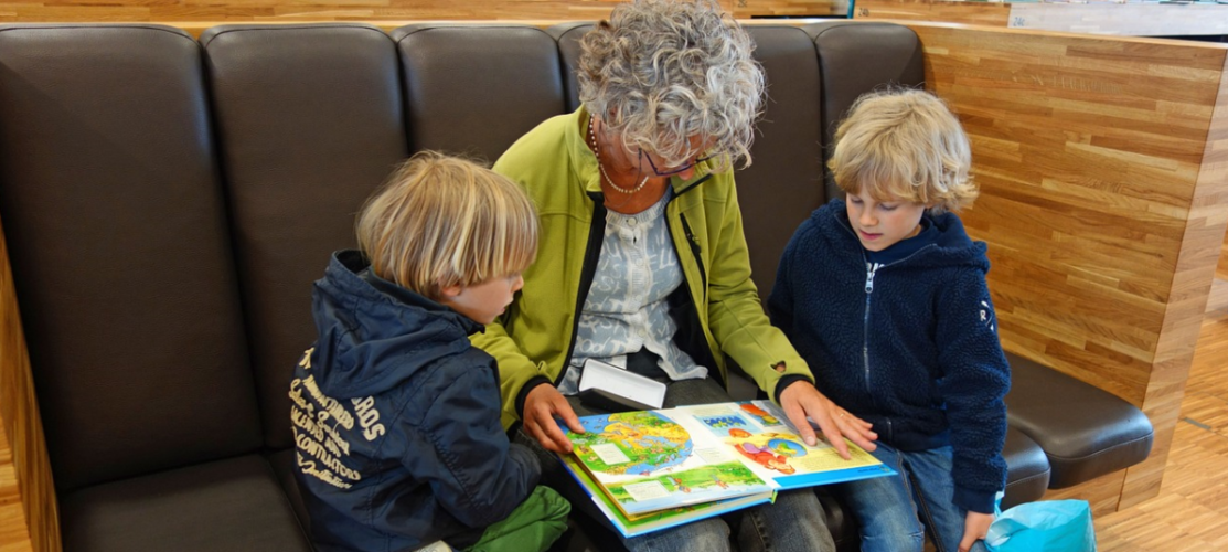 Older woman reading with children