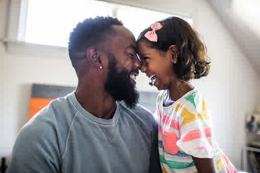 A child and her father are happy.