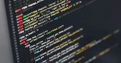 Close-up of a computer screen displaying lines of code in various programming languages.