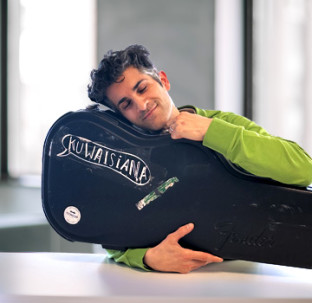 Aziz Ali hugging an instrument case