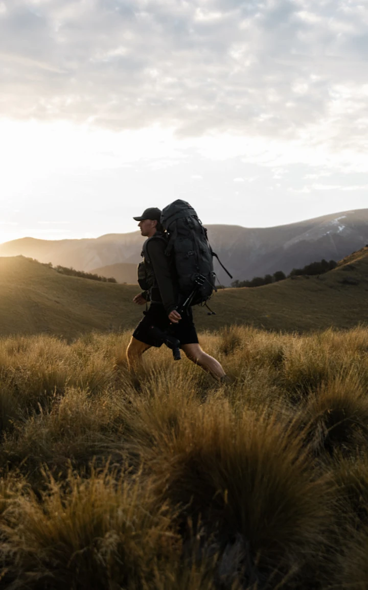 Man walking wearing Bushbuck gear with a full tramping pack