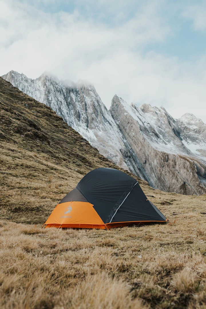 Horizon lightweight 2 person tent with a camper outdoors in dusk