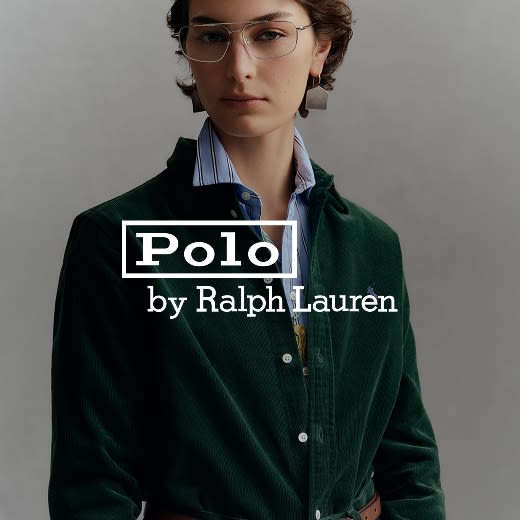 Model wearing a dark green corduroy button-down layered over a blue collared shirt.