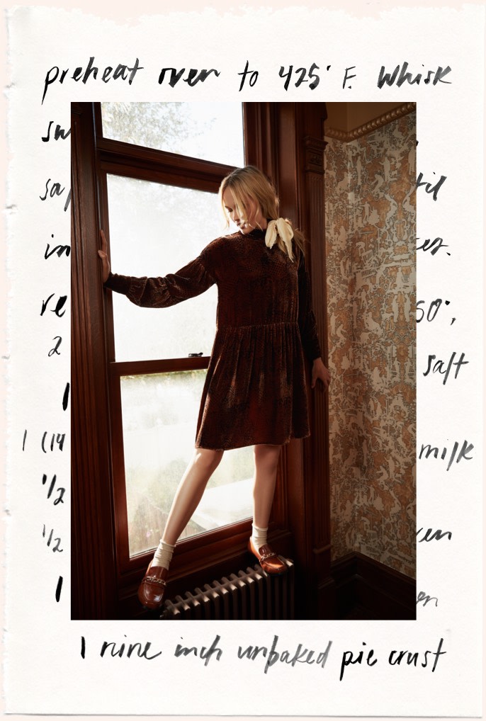 model in windowsill wearing brown velvet dress.