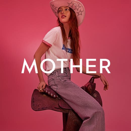 Model in a wide-brimmed bedazzled hat, graphic t-shirt, and wide-leg jeans posed on a saddle.