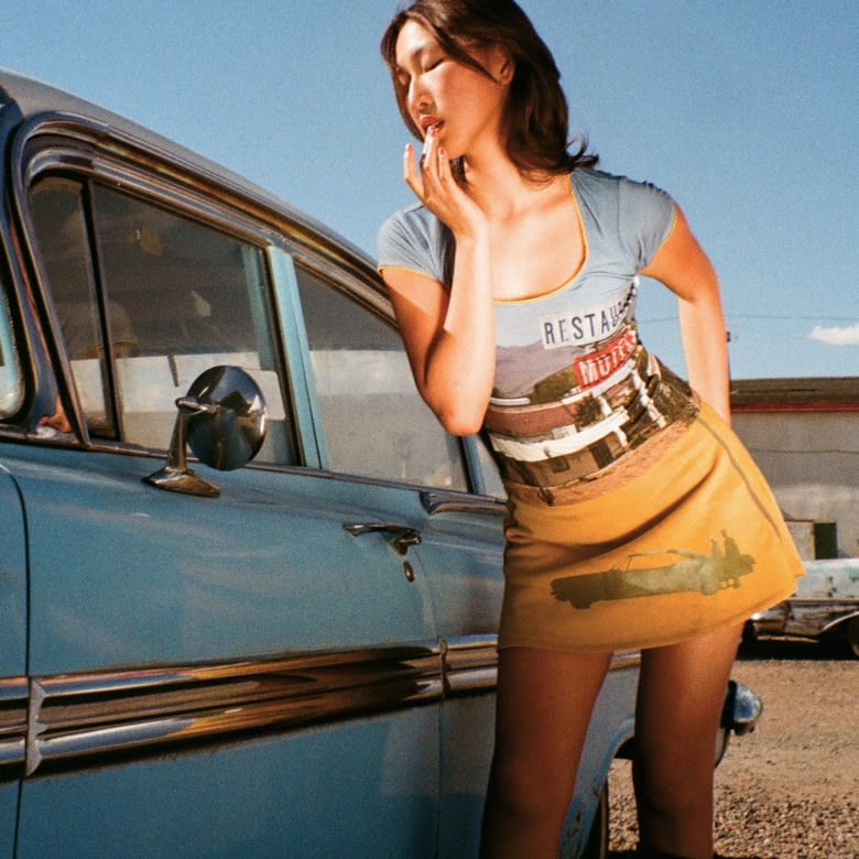 Women wearing graphic prints across halter dresses, pants, and a matching set. 