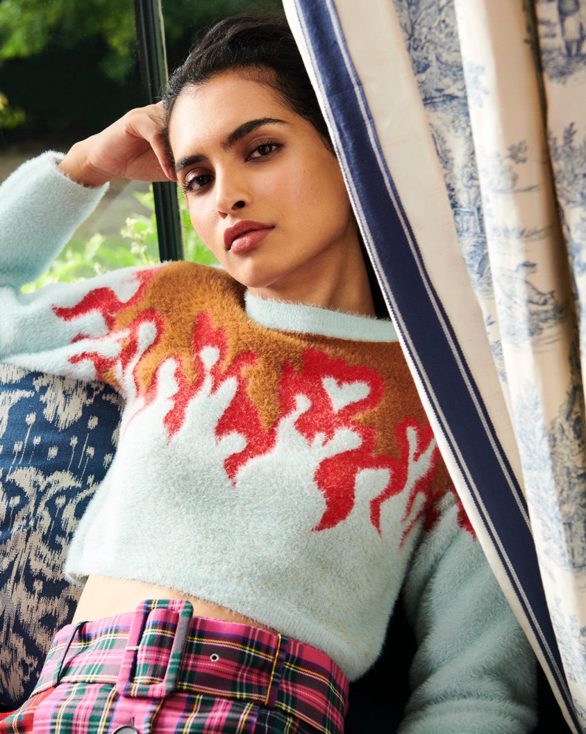 Soft crop sweaters with novelty prints paired with a bright pink plaid skirt.
