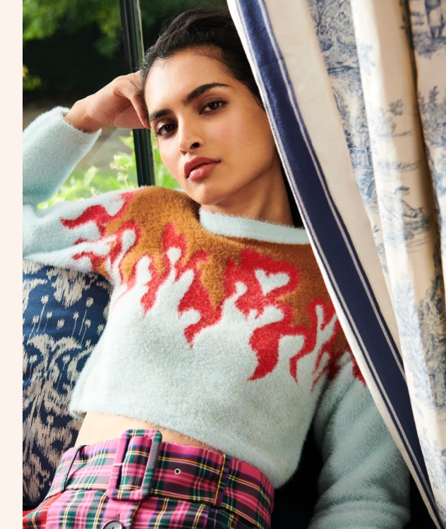 Soft crop sweaters with novelty prints paired with a bright pink plaid skirt.