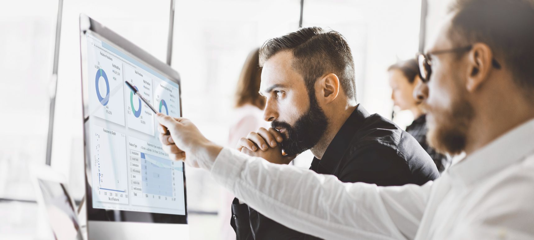 Two men looking at a monitor displaying an integrity assessment