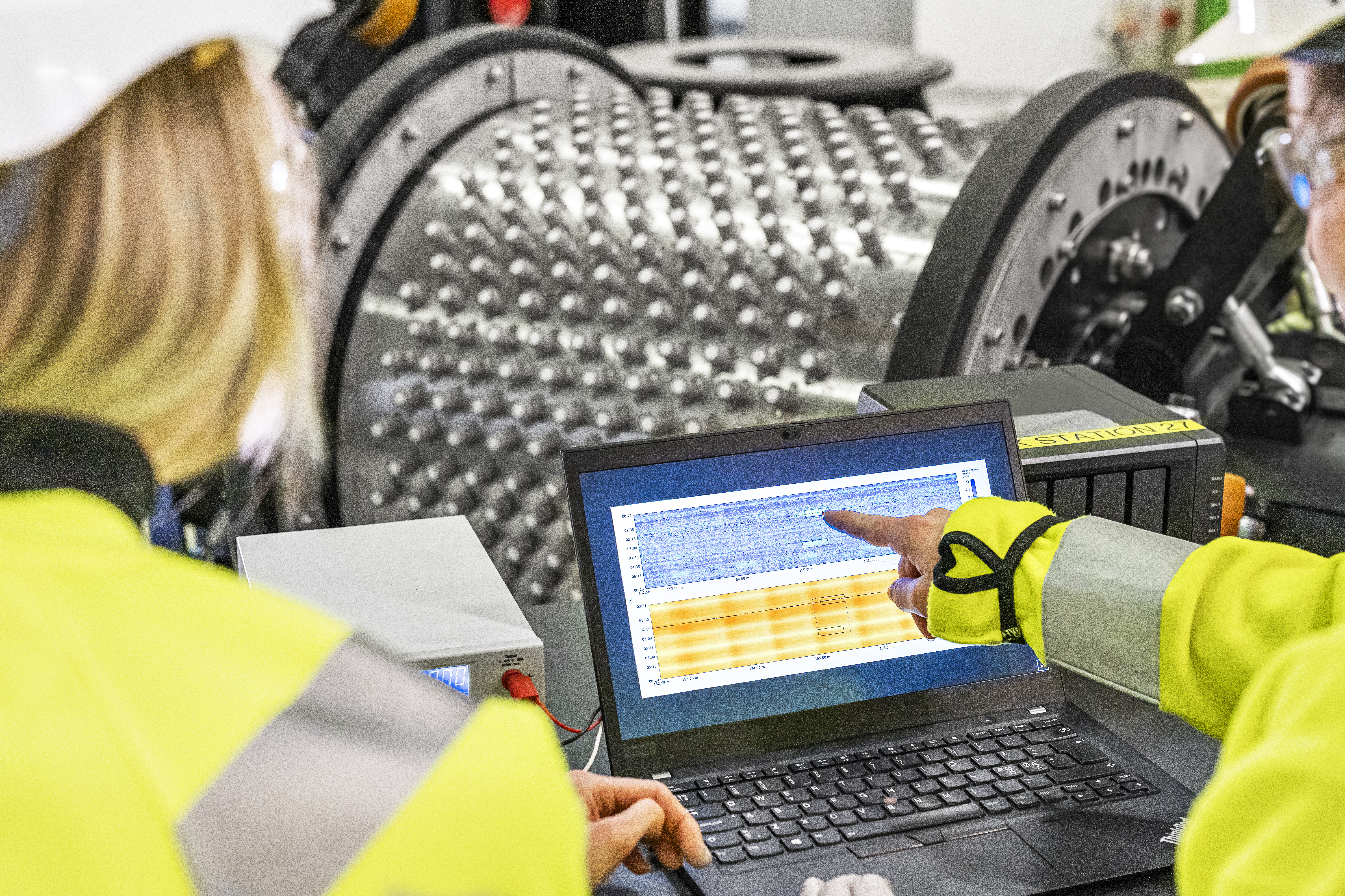 NDT Global employees inspecting data from a tool