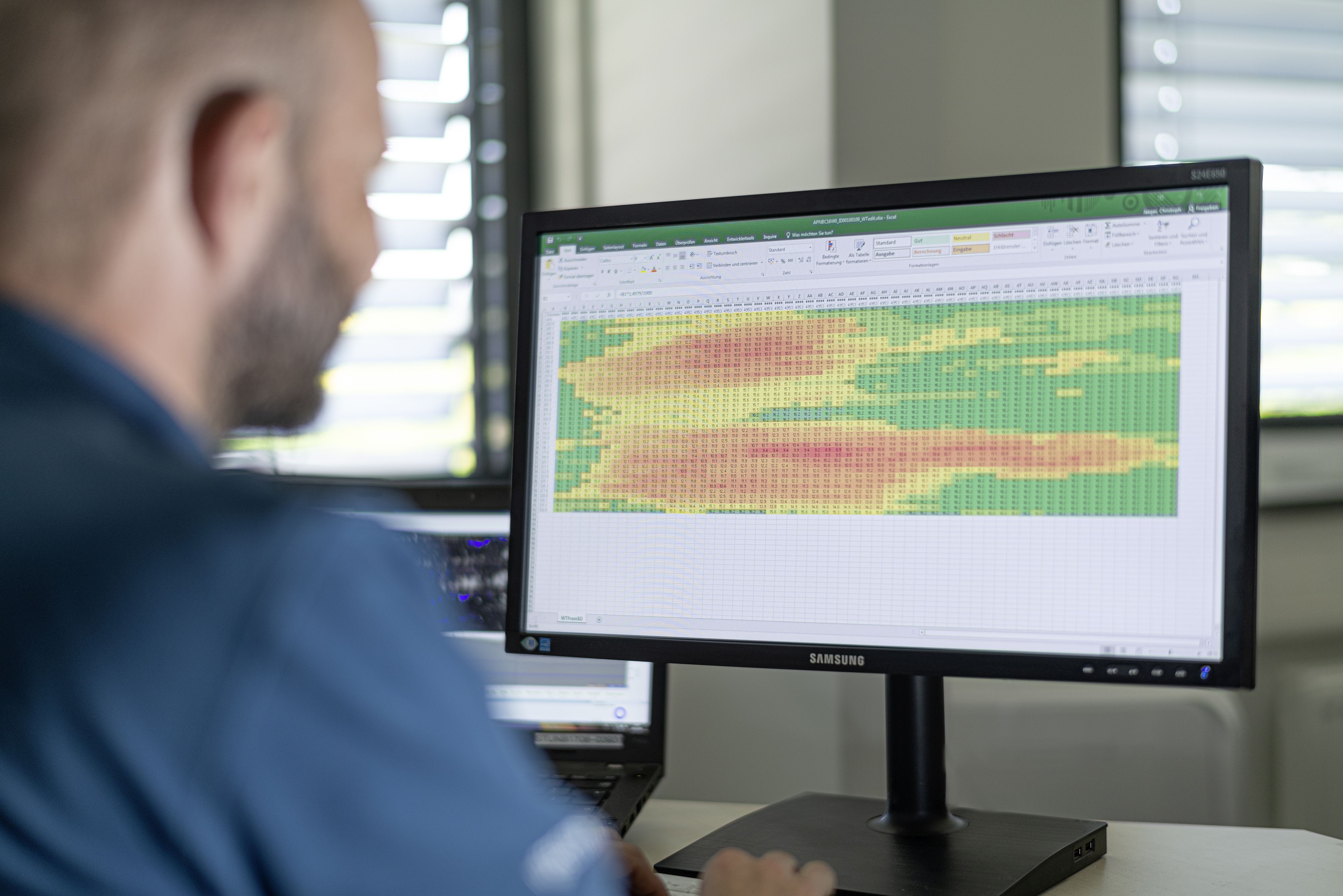 Man looking at data on a monitor