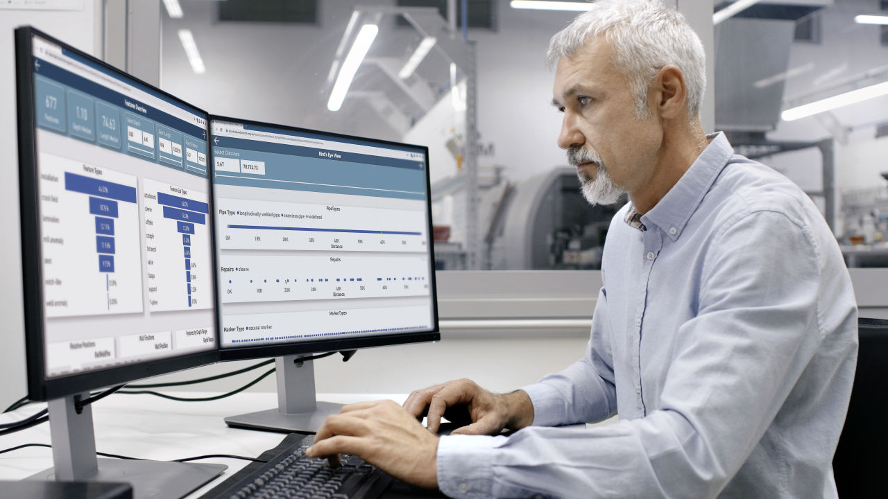 Man looking at data visualization on a monitor