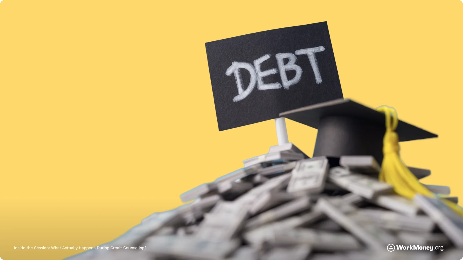 A pile of money with a sign that says debt on it.