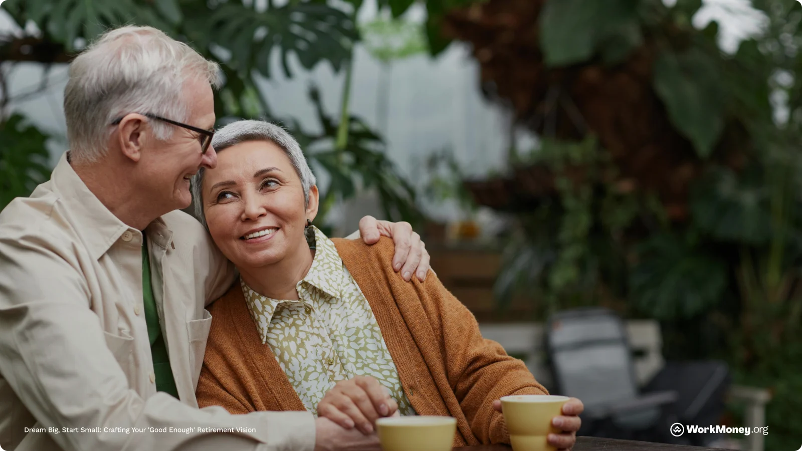 An older couple hug drinking coffee