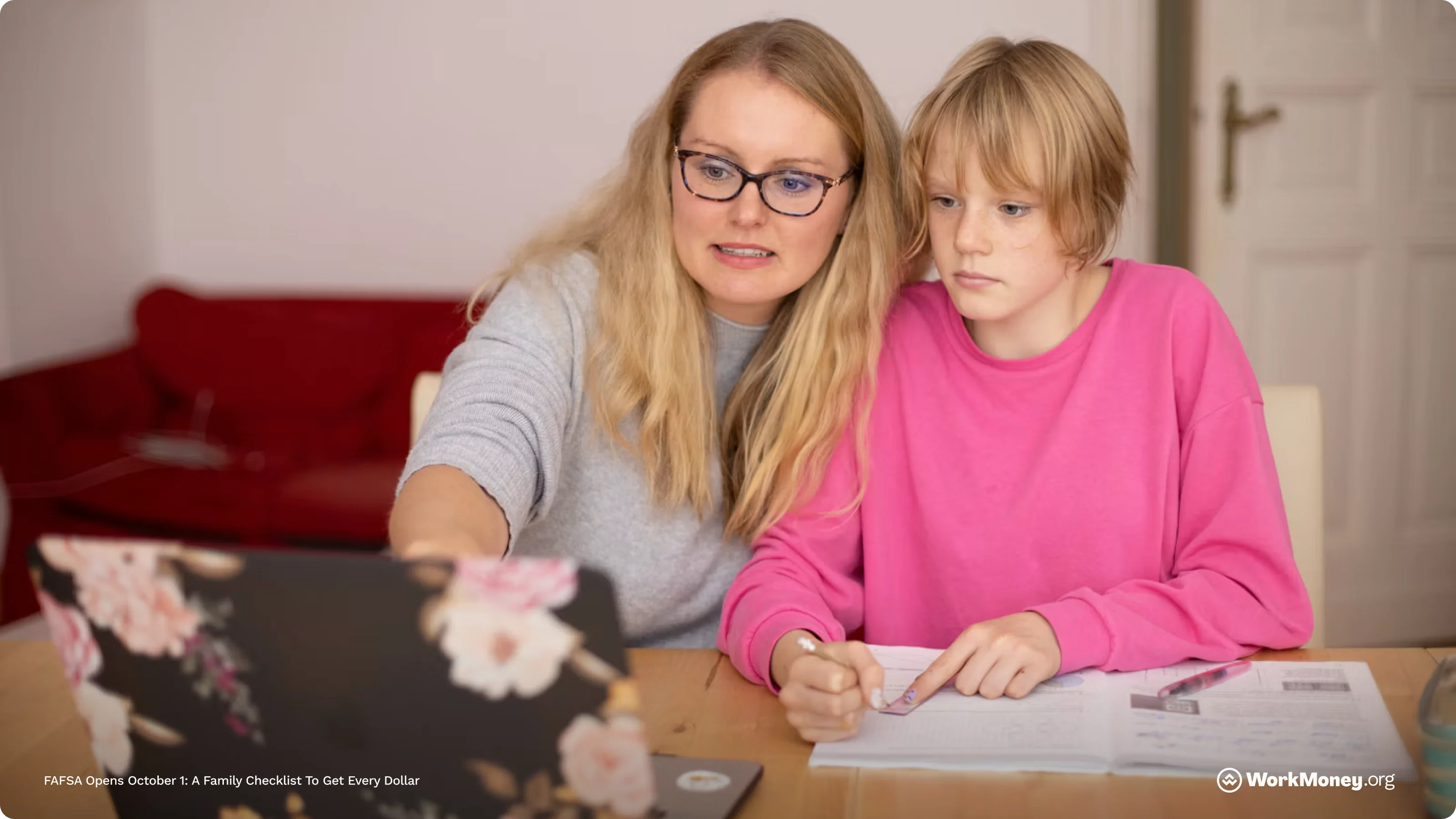 A mother and daughter look at a computer and consider a FAFSA application.