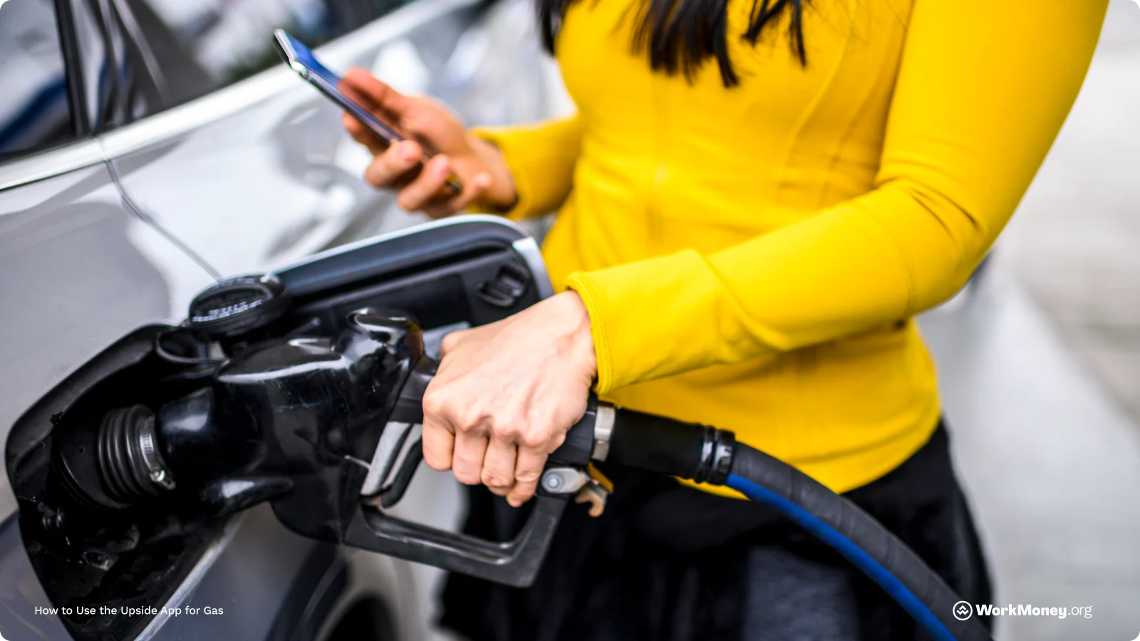Person pumping gas in a yellow shirt