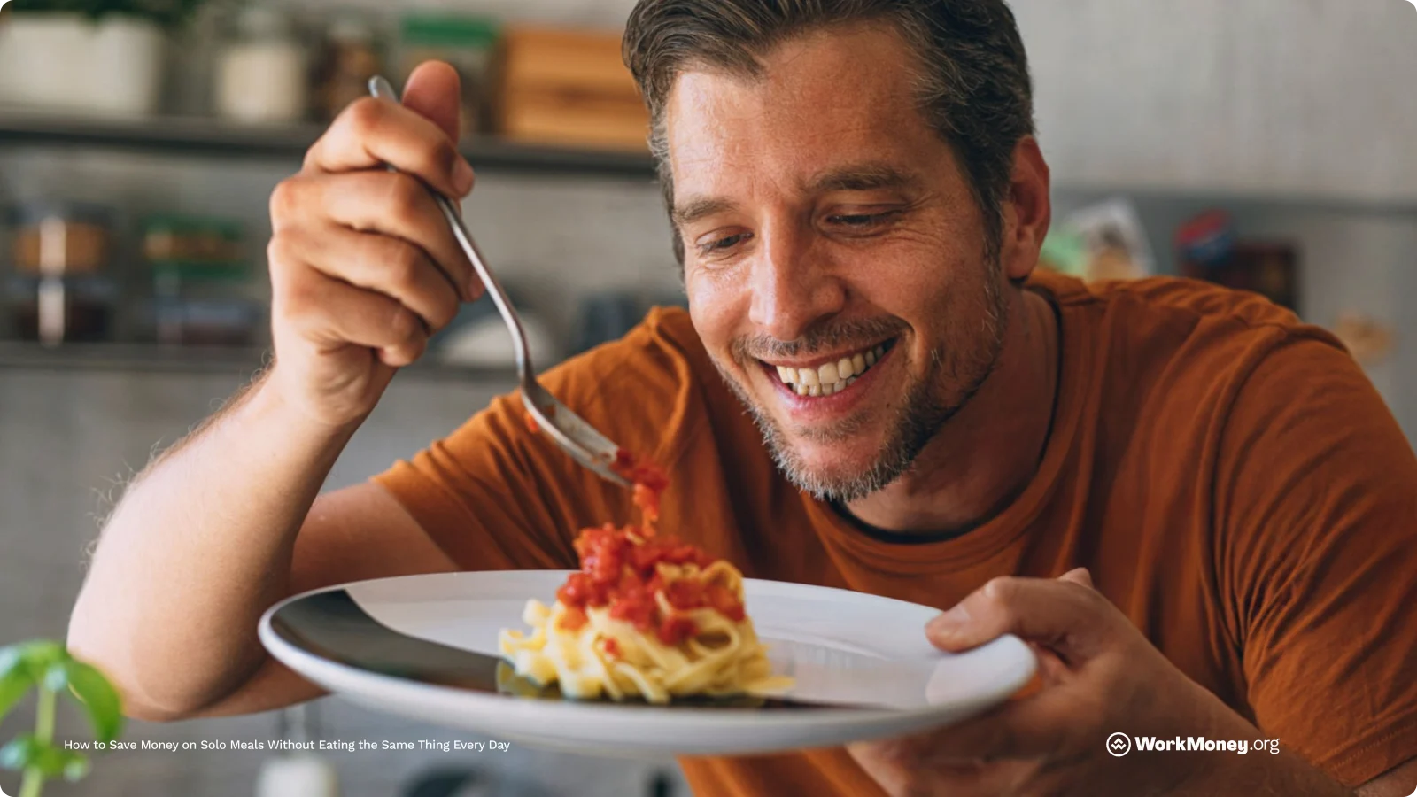 A man happily eats a pasta meal alone, illustrating how to save money on solo meals without sacrificing variety or enjoyment.