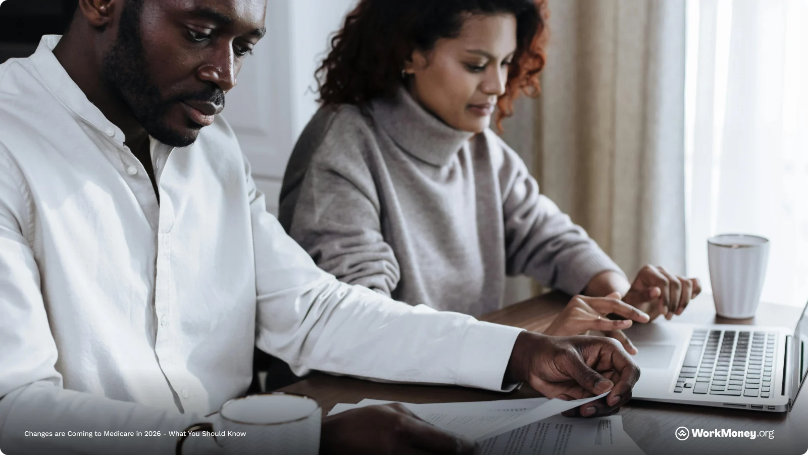 A couple reviews medical papperwork about healthcare insurance together.