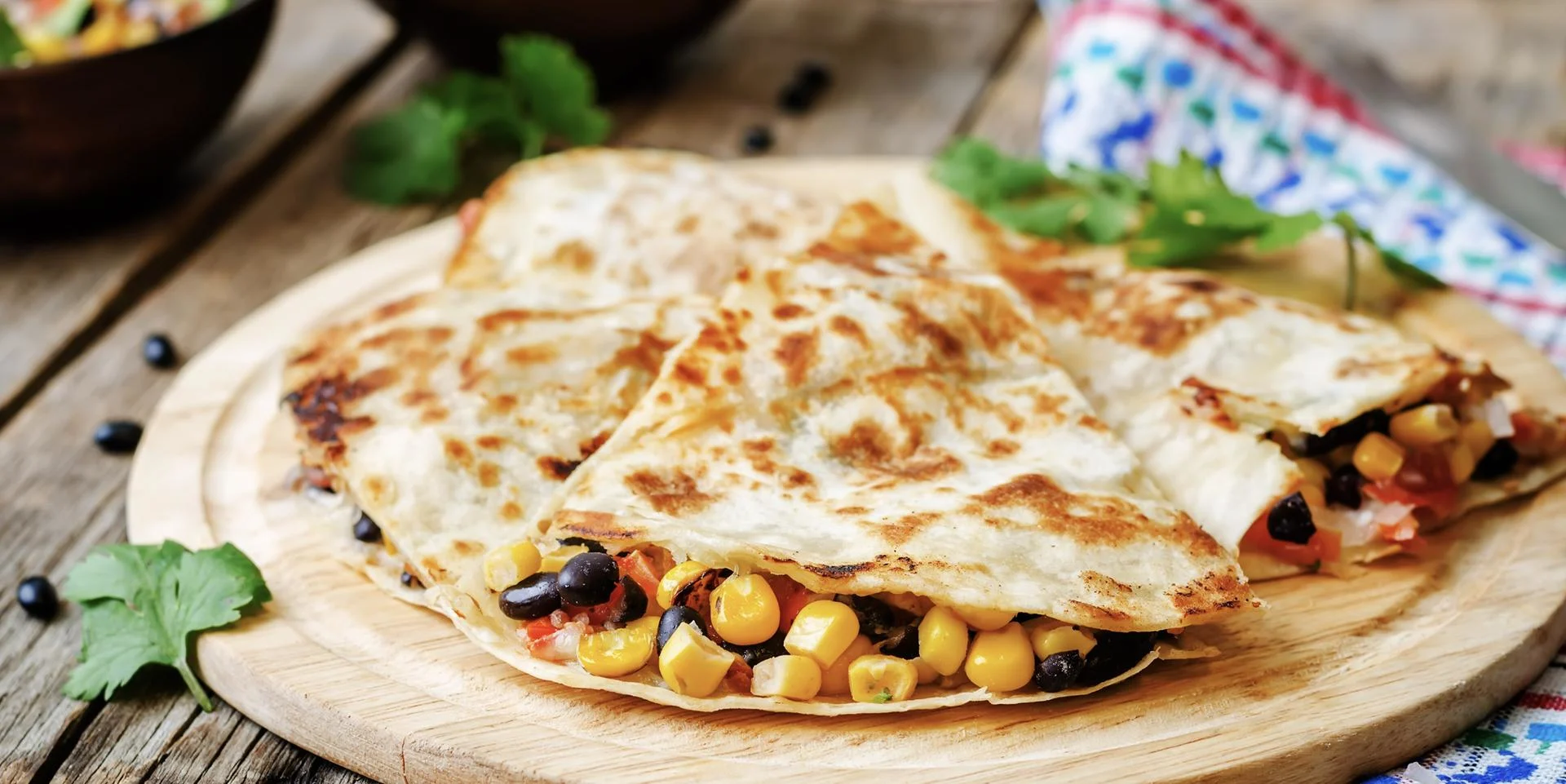 A plate of quesadillas sits cut up ready to eat.