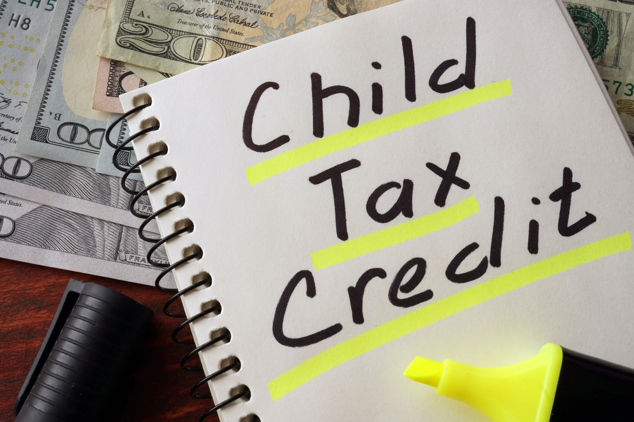 Notepad with the word "Child Tax Credit" written on it and highlighted underneath in yellow