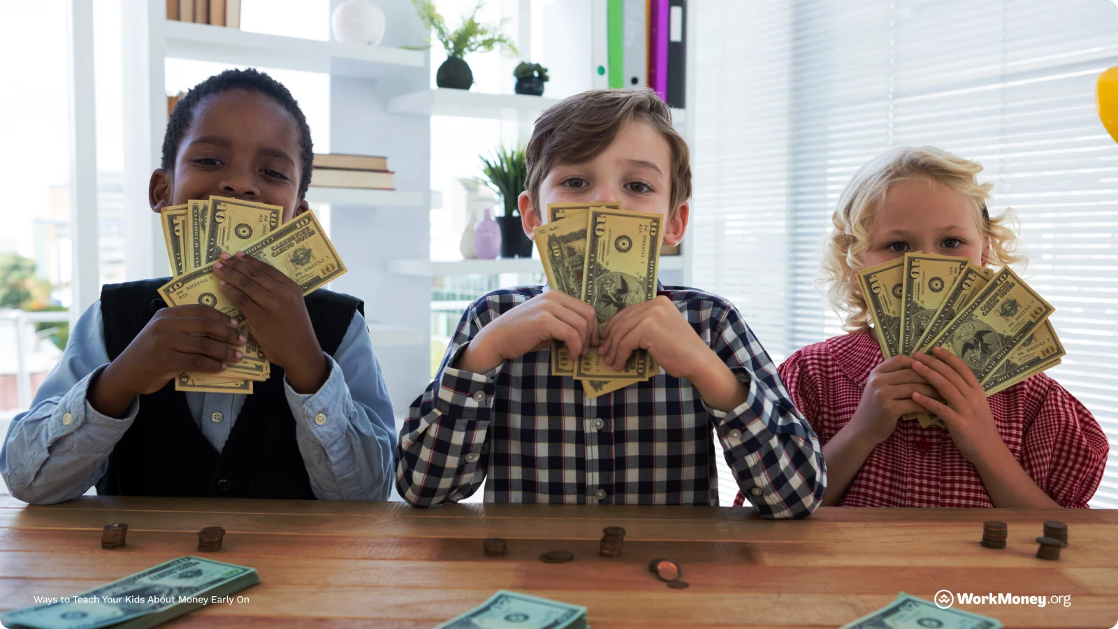 Group of kids holding up dollar bills